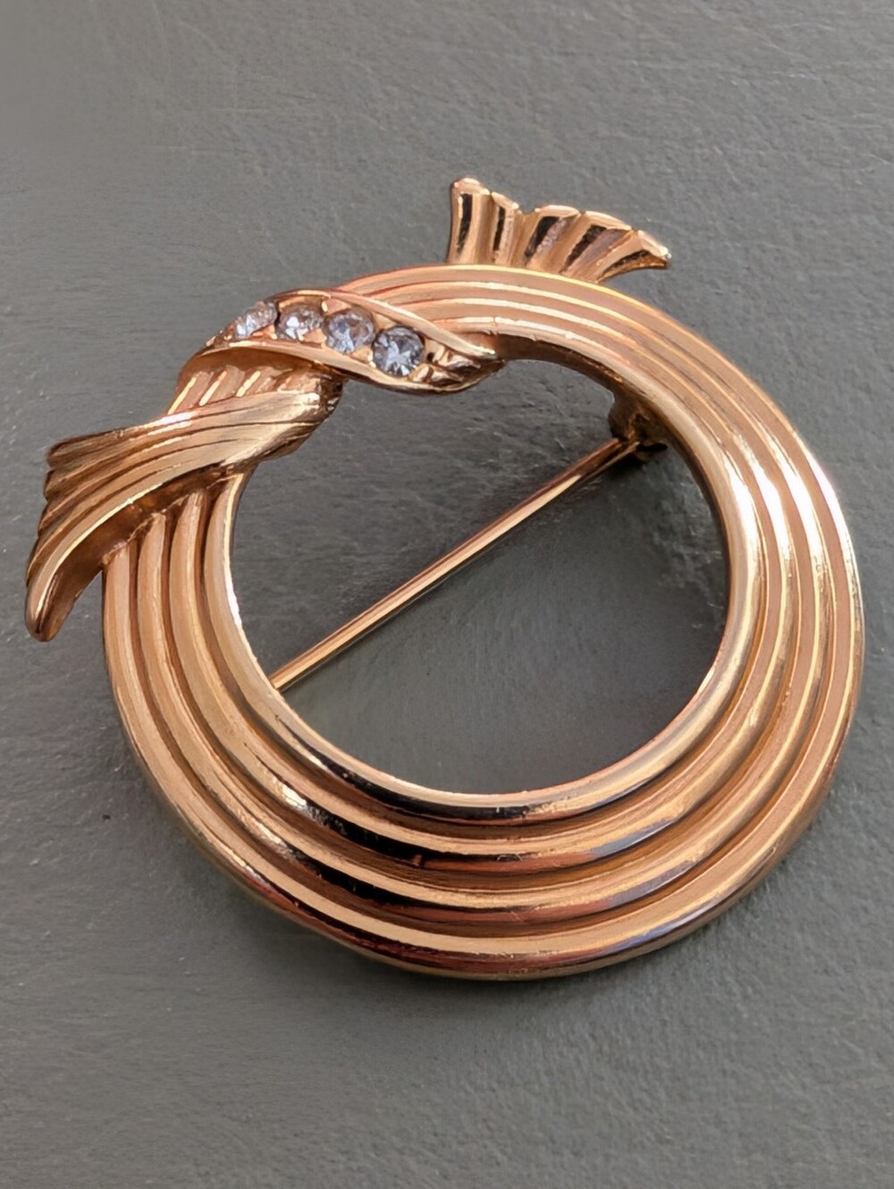 Vintage Avon Gold-Tone Circular Ribbon Brooch with Crystal Accents